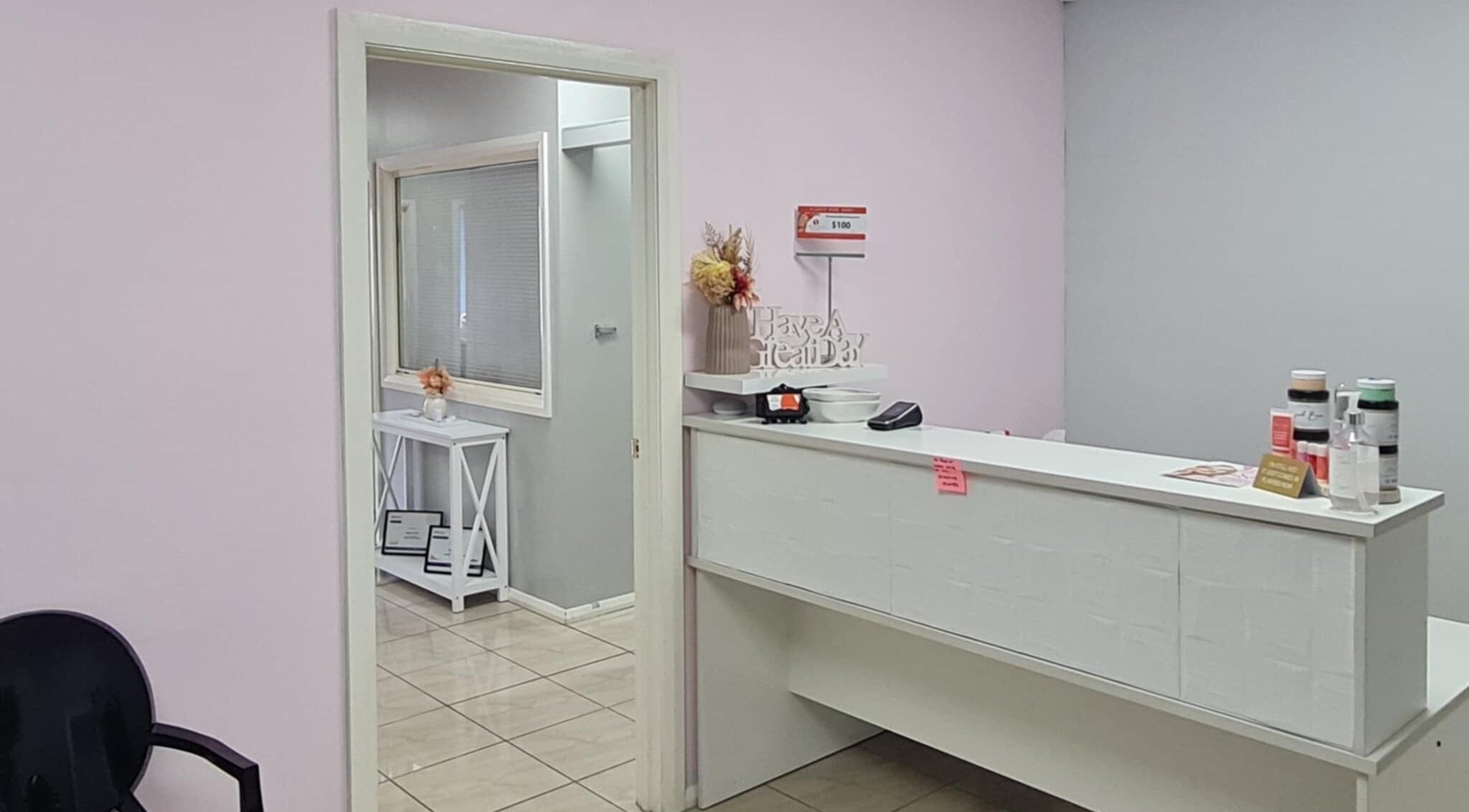 Reception area at Slimming Studio - Narellan, Narellan, New South Wales, AU, featuring a sleek desk and decor.