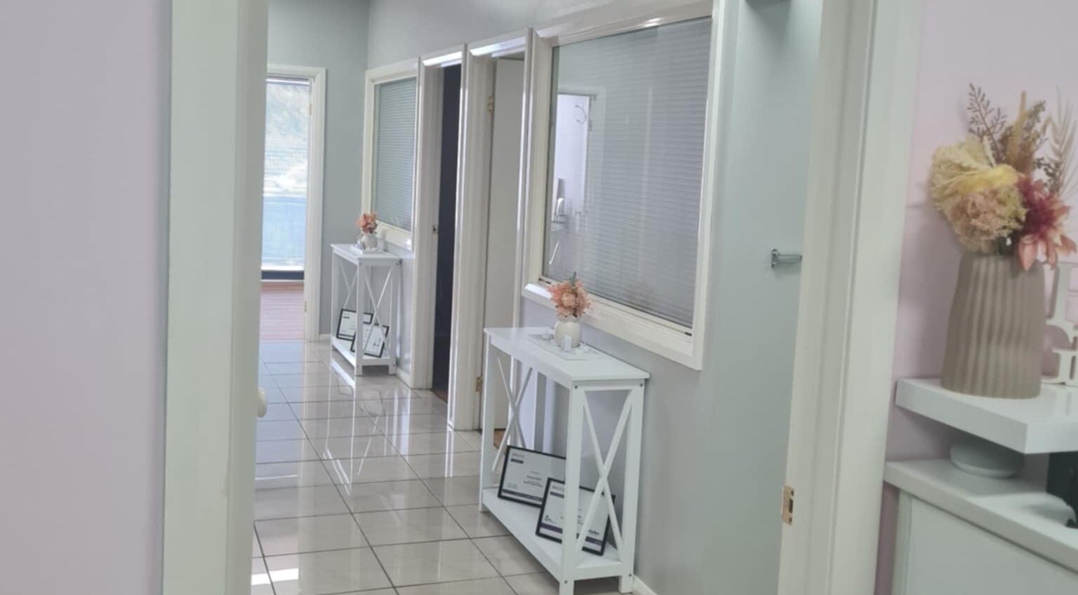 Bright hallway at Slimming Studio - Narellan, Narellan, New South Wales, AU with decor and certificates.