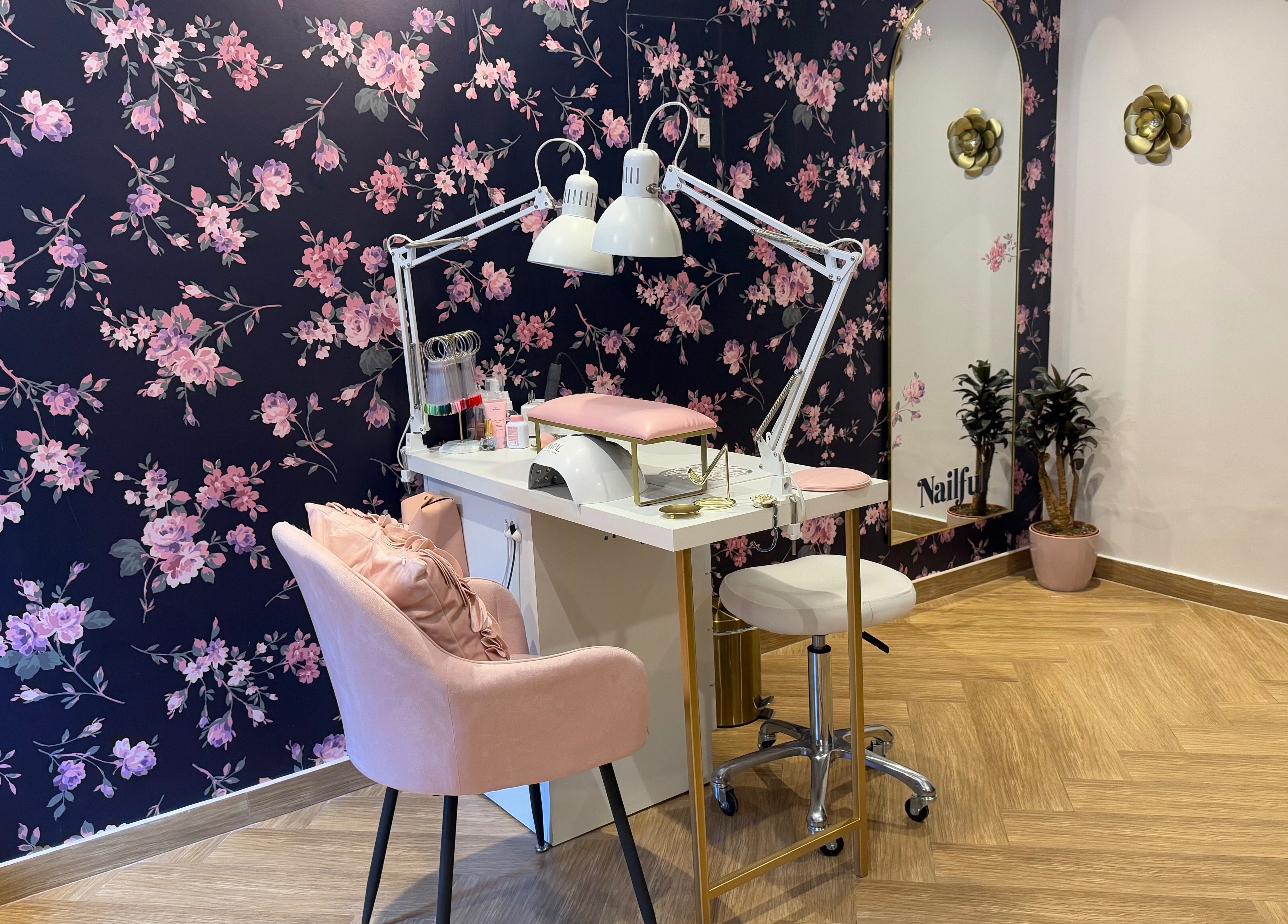 Chic nail station at Nailful Salon, Jeddah, Makkah Province, SA, with floral wall and pink seating.