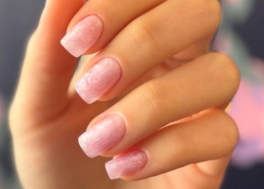 Soft pink manicured nails from Nailful Salon in Jeddah, Makkah Province, SA, showcasing delicate artistry.