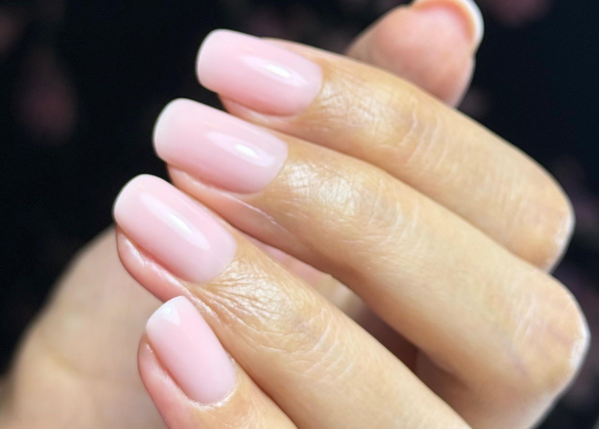Elegant, glossy pink nails at Nailful Salon, Jeddah, Makkah Province, SA, showcasing artistry and care.