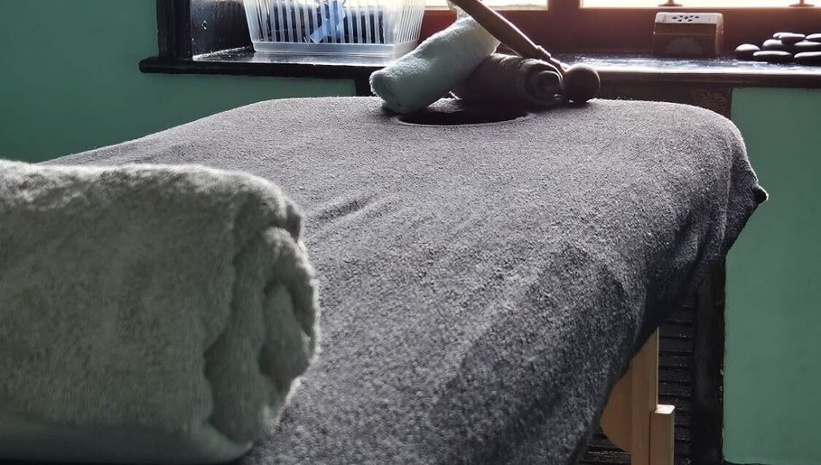 Cozy massage table at Relax Massage & Wellness in Darwen, England, GB, prepared with plush towels for a soothing session.