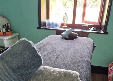 Tranquil massage room at Relax Massage & Wellness in Darwen, England, GB, featuring a cozy massage table.