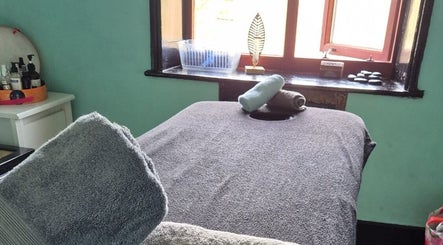 Tranquil massage room at Relax Massage & Wellness in Darwen, England, GB, featuring a cozy massage table.