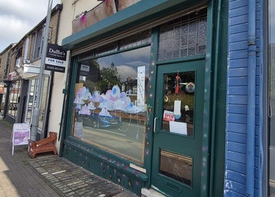 Relax Massage & Wellness on a bustling street in Darwen, England, showcasing its inviting storefront.