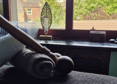 Tranquil massage tools at Relax Massage & Wellness, Darwen, England, GB, amidst a peaceful window view.
