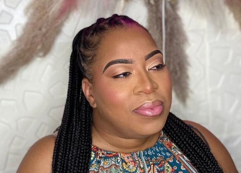 Woman with braided hair and makeup at Styles By Kera, Roseau, Saint George Parish, DM.