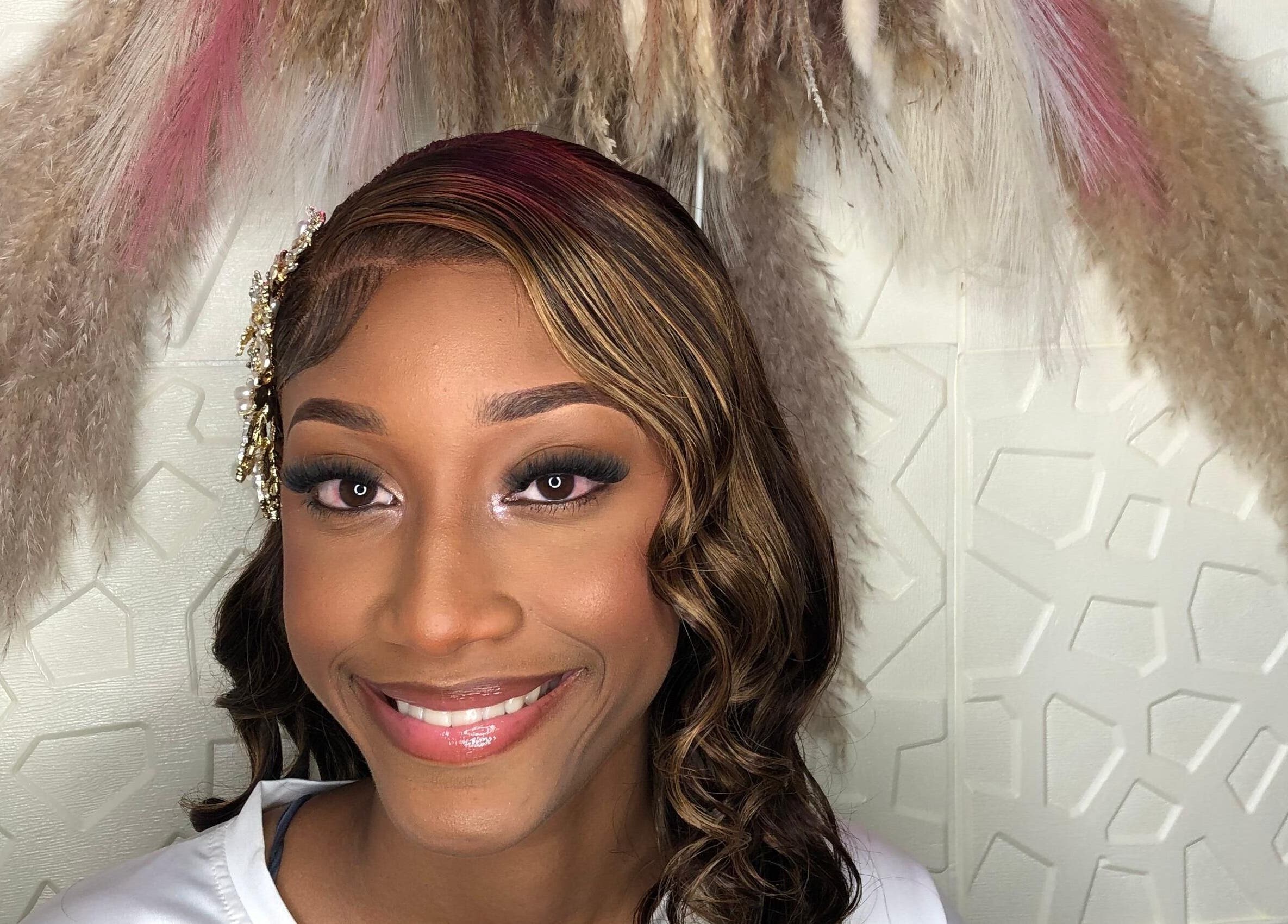 A woman with styled hair and elegant makeup at Styles By Kera in Roseau, Saint George Parish, DM.