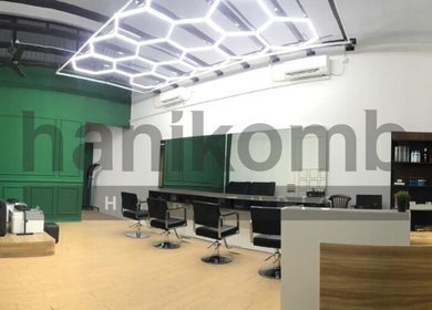 Modern design of Hanikomb Hair Studio in Johor Darul Ta'zim, MY with sleek seating and green accents.