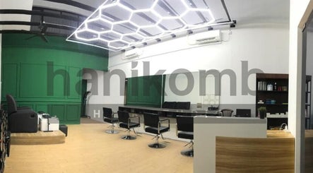 Modern design of Hanikomb Hair Studio in Johor Darul Ta'zim, MY with sleek seating and green accents.