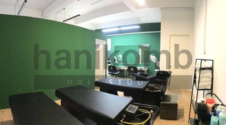 Modern styling area at Hanikomb Hair Studio in Johor Darul Ta'zim, MY with sleek green and black interior.