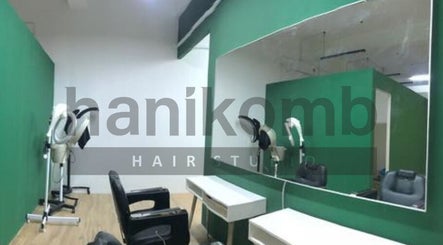 Modern interior of Hanikomb Hair Studio, Johor Darul Ta'zim, with sleek mirrors and styling chairs.