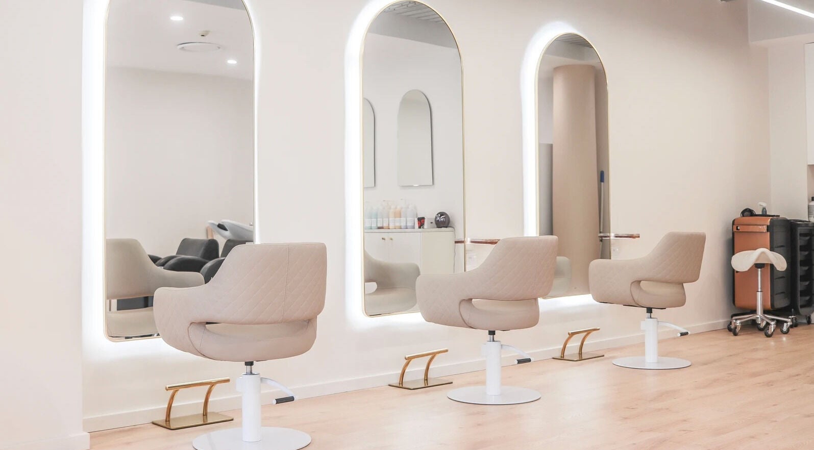 Modern salon chairs and mirrors at Ostara Hair, Surry Hills, New South Wales, AU, showcasing elegant design.