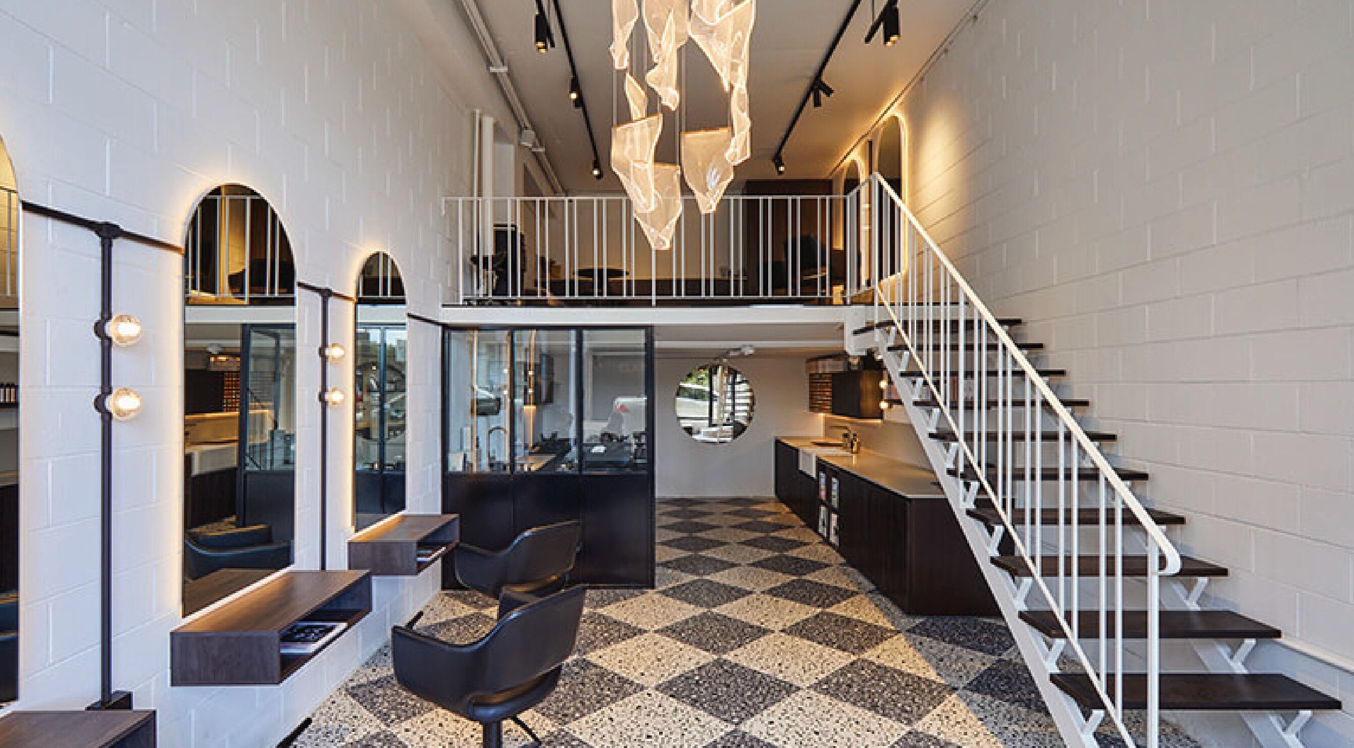 Modern interior of Elaine George Salon loft in Melbourne, Victoria, AU featuring stylish decor and a mezzanine.