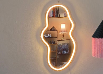 Curved mirror with warm glow at Gelli Jam, Burswood, Western Australia, AU reflecting a cozy interior.