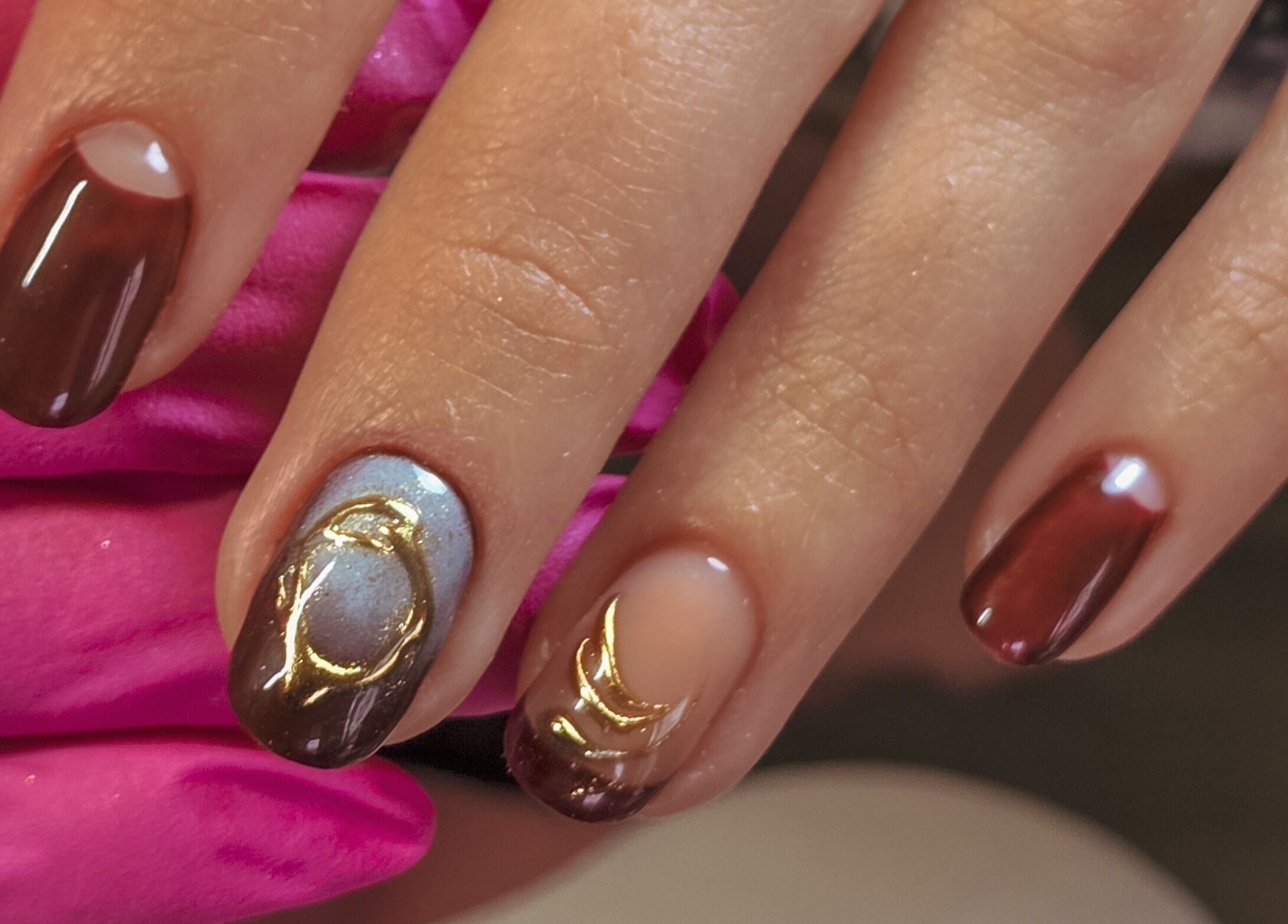 Artfully painted nails showcasing gold and maroon designs at Gelli Jam, Burswood, Western Australia, AU.