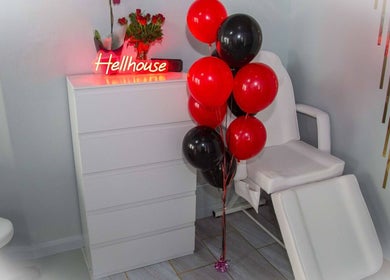Stylish Hellhouse salon room in Norwich, England, GB with red balloons and chic decor.