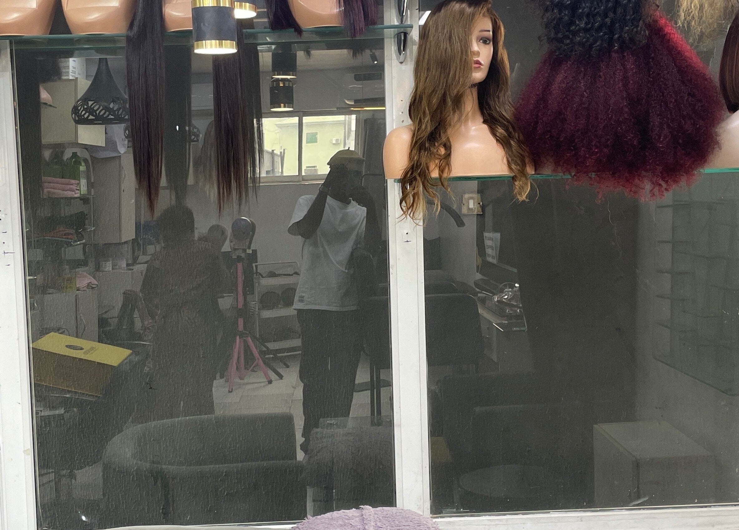 Display of diverse wigs at HairByTreapotter, Lagos, Lagos, NG for stylish hair transformations.