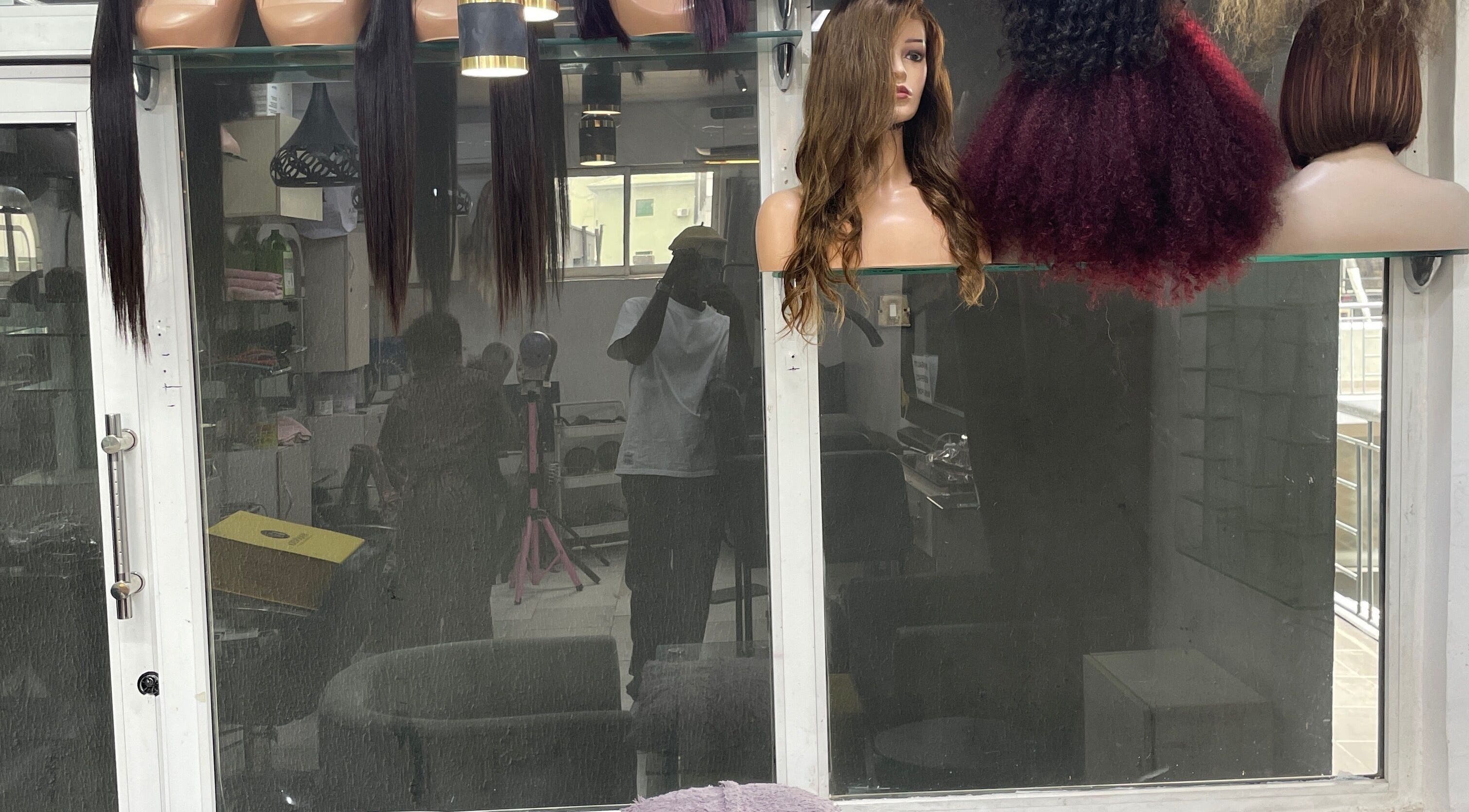 Display of diverse wigs at HairByTreapotter, Lagos, Lagos, NG for stylish hair transformations.