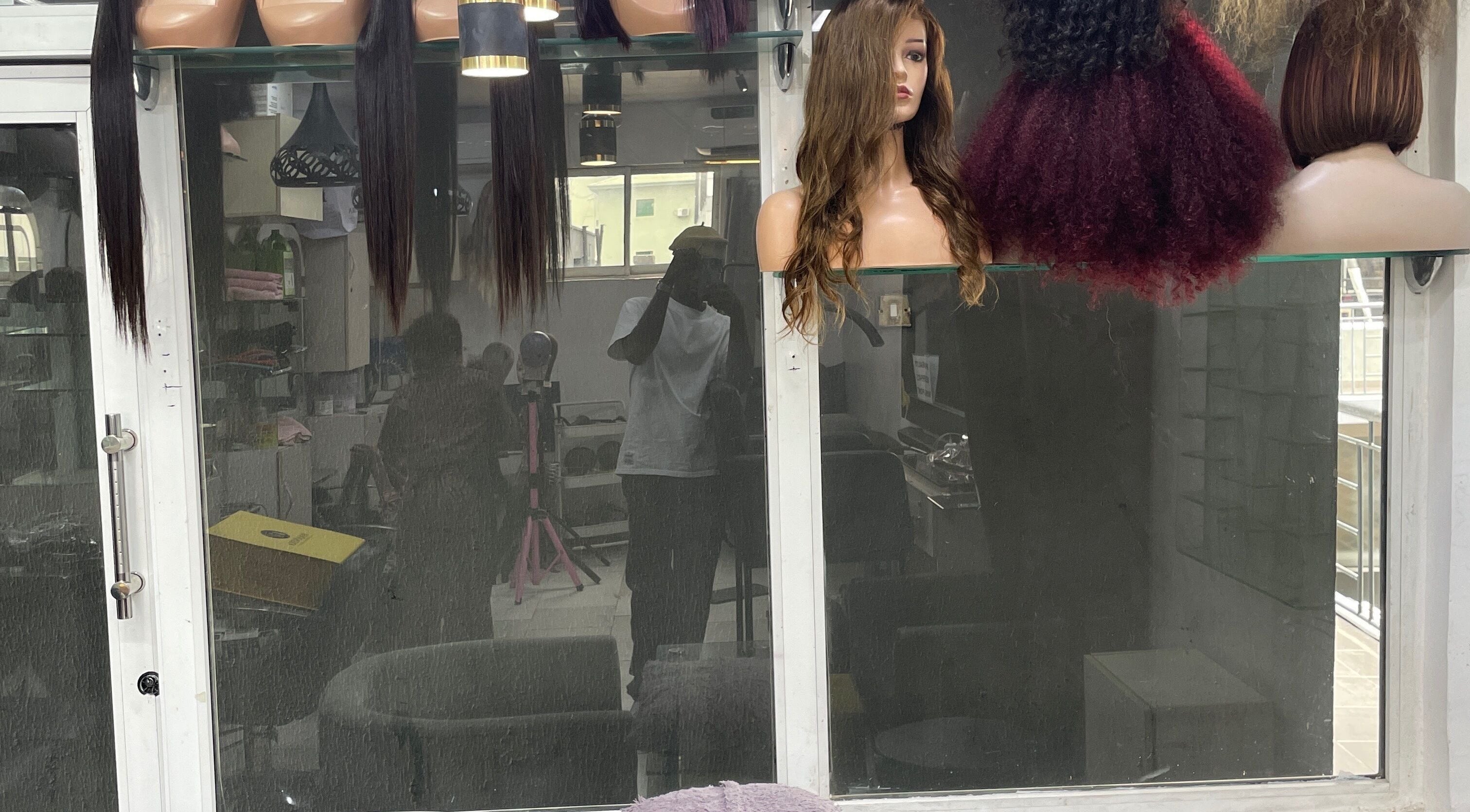 Display of diverse wigs at HairByTreapotter, Lagos, Lagos, NG for stylish hair transformations.