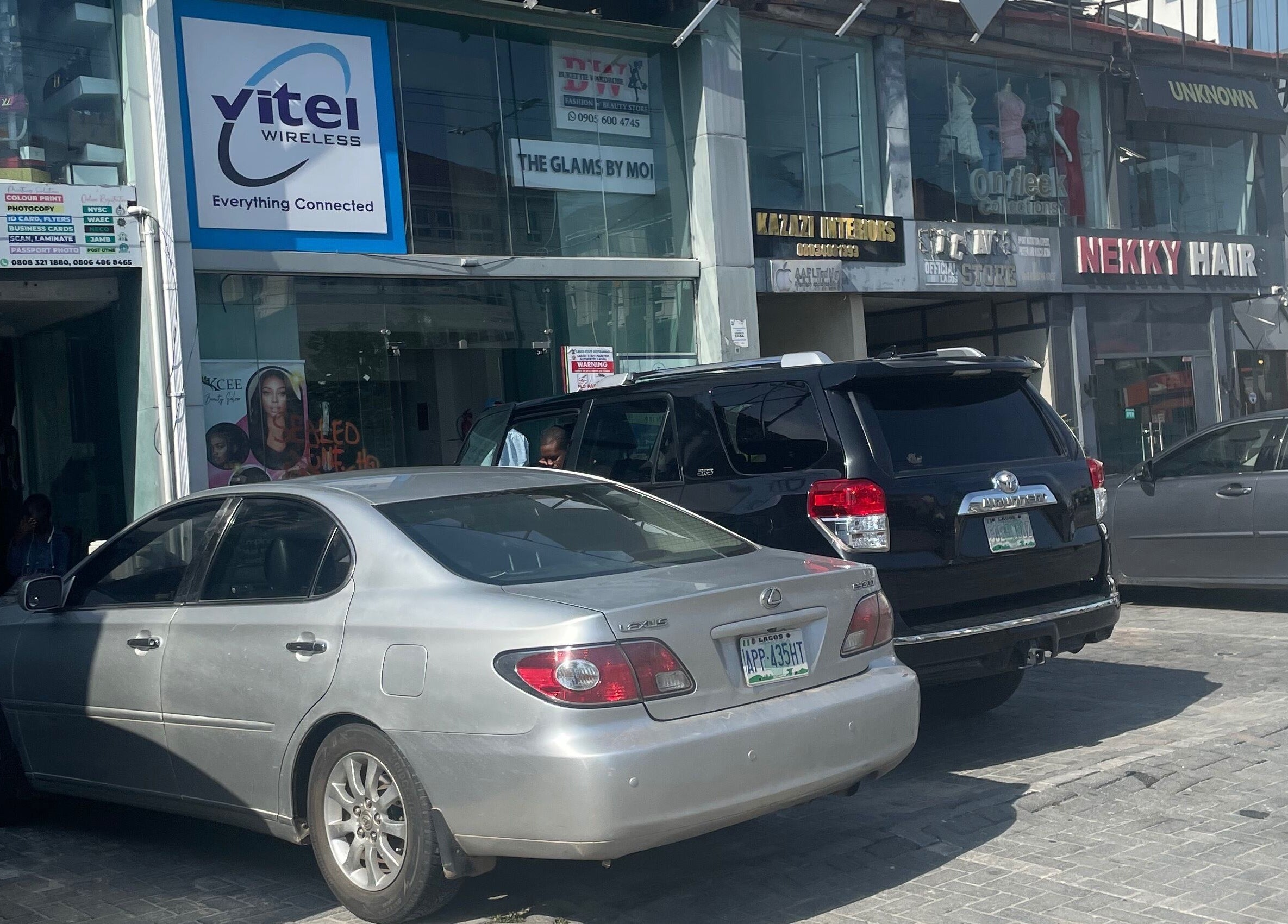 Exterior view of HairByTreapotter at Lagos, Lagos, NG, showcasing street and parking area.