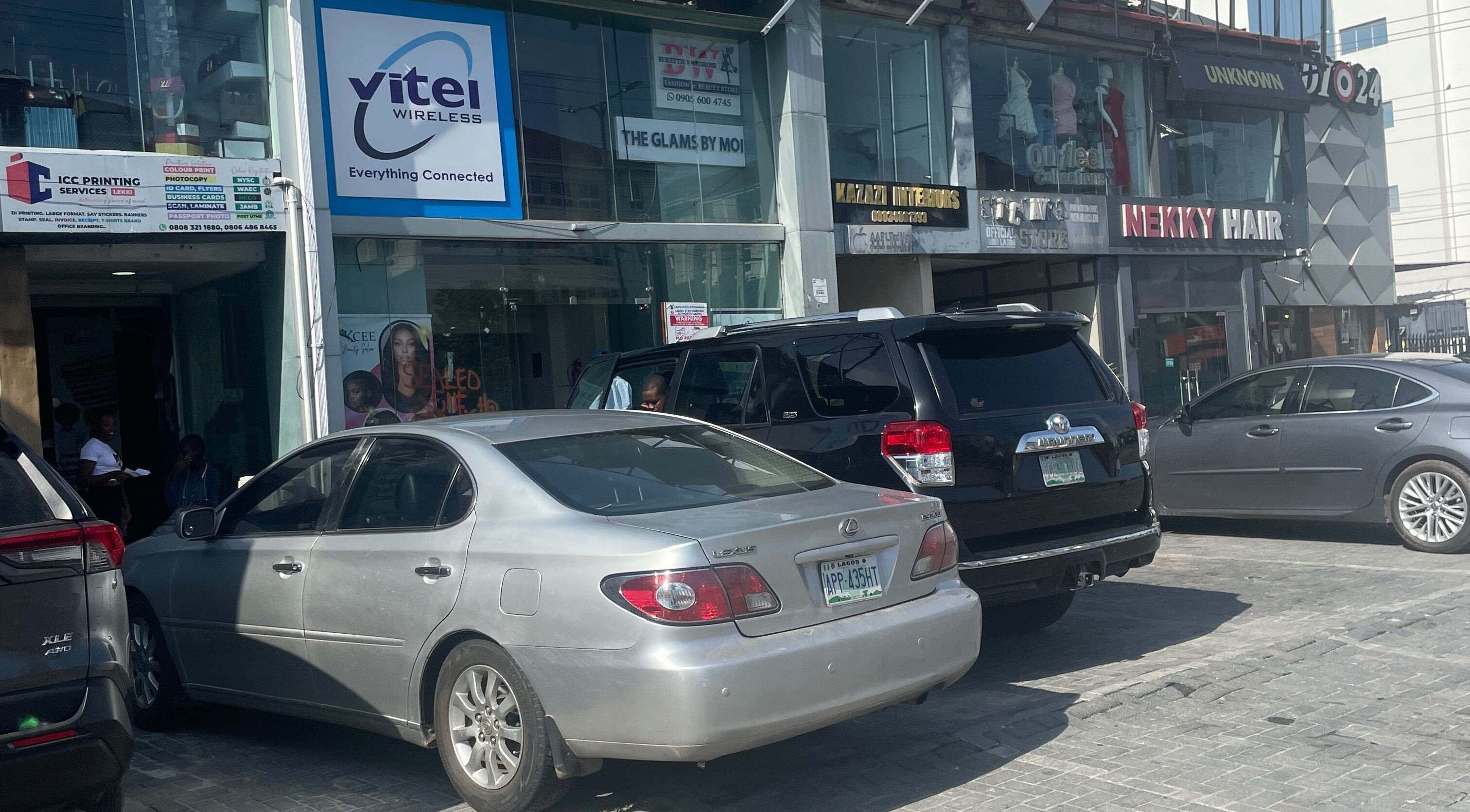 Exterior view of HairByTreapotter at Lagos, Lagos, NG, showcasing street and parking area.