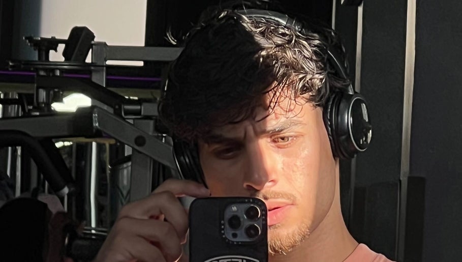 Person wearing headphones taking a selfie in the gym at Mustafa Cuts, Sala Al Jadida, Rabat-salé-kénitra, MA.