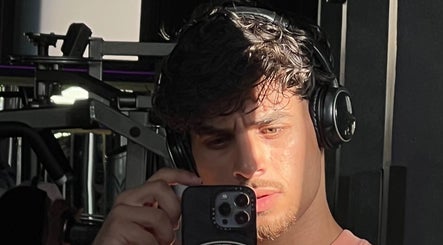 Person wearing headphones taking a selfie in the gym at Mustafa Cuts, Sala Al Jadida, Rabat-salé-kénitra, MA.