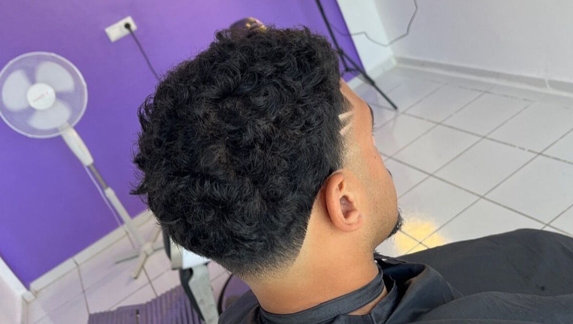 Stylish curly fade haircut at Mustafa Cuts, Sala Al Jadida, Rabat-salé-kénitra, MA.