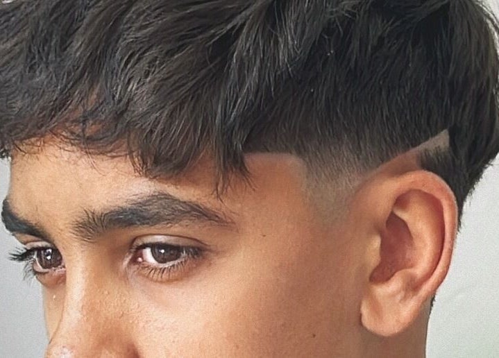 Stylish modern haircut at Mustafa Cuts, Sala Al Jadida, Rabat-salé-kénitra, MA, showcasing expert fade design.