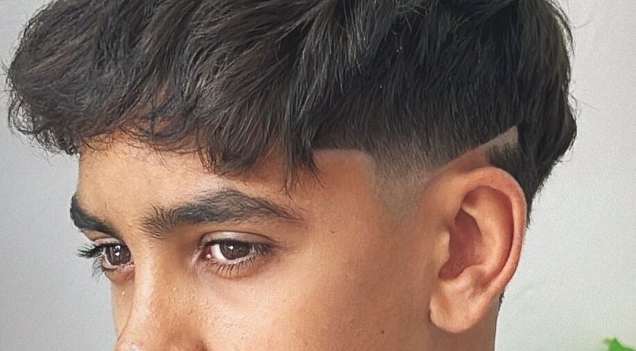 Stylish modern haircut at Mustafa Cuts, Sala Al Jadida, Rabat-salé-kénitra, MA, showcasing expert fade design.