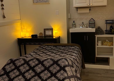 Calming wellness room at Soul Craft Coaching & Wellness, Lapeer, Michigan, US with massage bed and soothing lights.