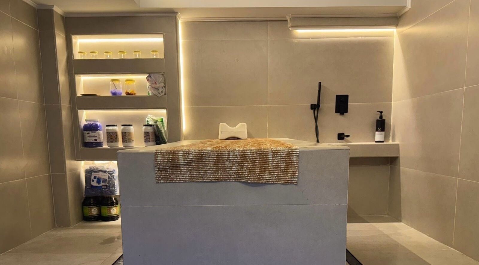 Modern treatment room at Classy Salon, Ajman, AE, featuring sleek shelves with beauty products.