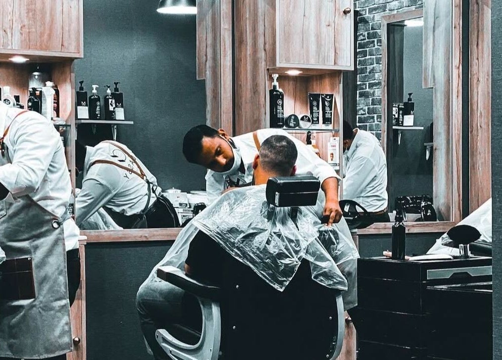 Professional barber giving a stylish haircut at Classy Salon, Ajman, Ajman, AE.
