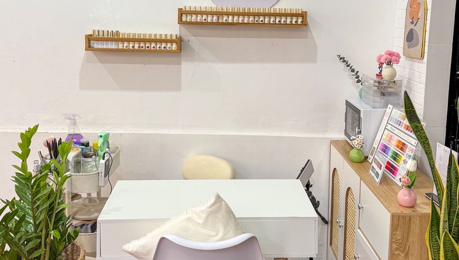 Nails By Nks manicure table with polish display in Phnom Penh, Phnom Penh, KH. Inviting and organized space.