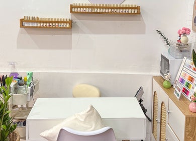 Nails By Nks manicure table with polish display in Phnom Penh, Phnom Penh, KH. Inviting and organized space.