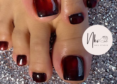 Elegant pedicure with deep red polish at Nails By Nks, Phnom Penh, Phnom Penh, KH.