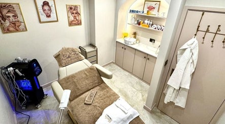 Elegant treatment room at Shefa Beauty Lounge, London, England, showcasing spa bed and skincare products.