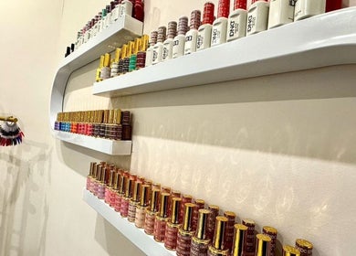 Vibrant nail polish display at Shefa Beauty Lounge, London, England, GB, showcasing various colors.