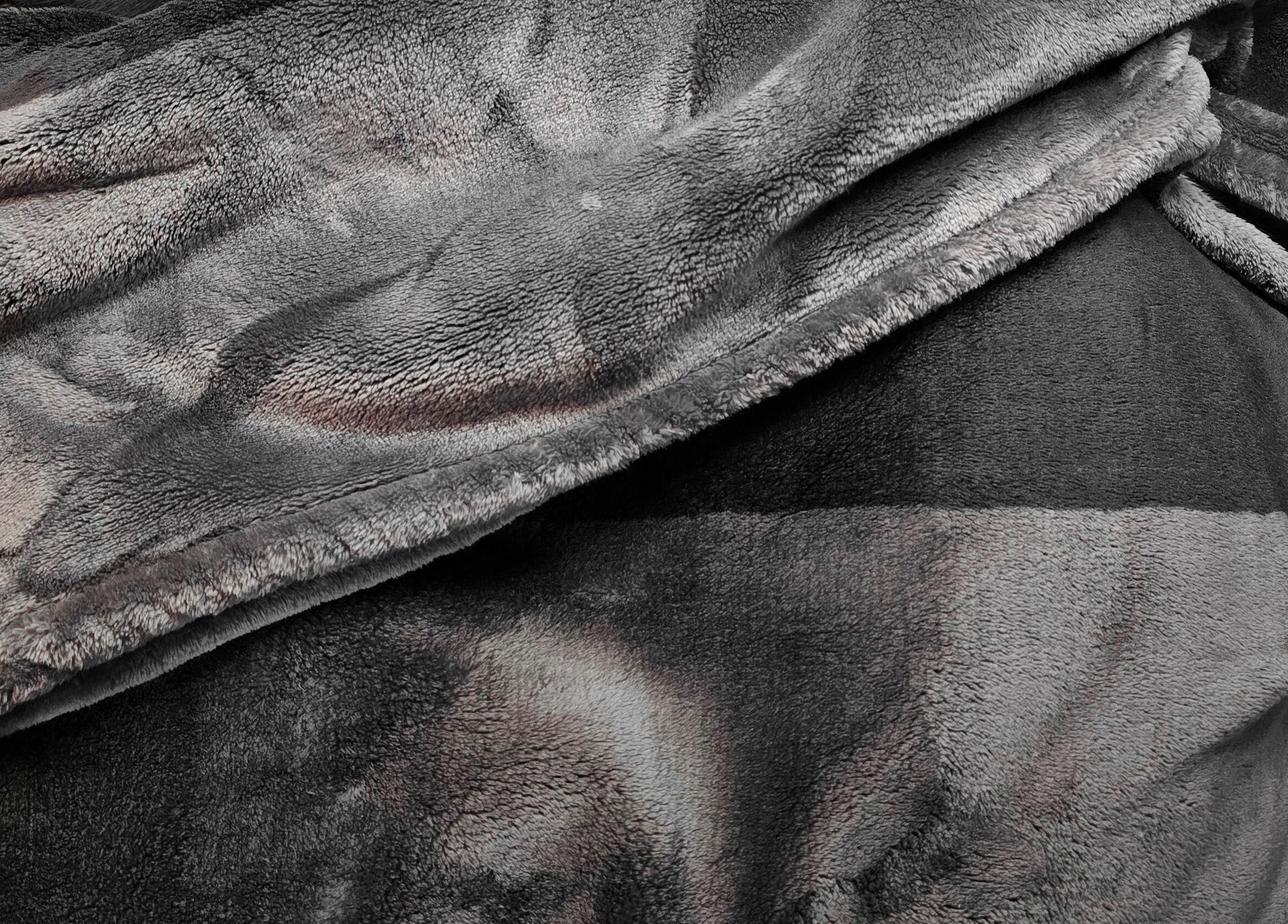 Plush grey blanket at Dalight Lashes, Winnipeg, Manitoba, CA offering maximum comfort and relaxation.