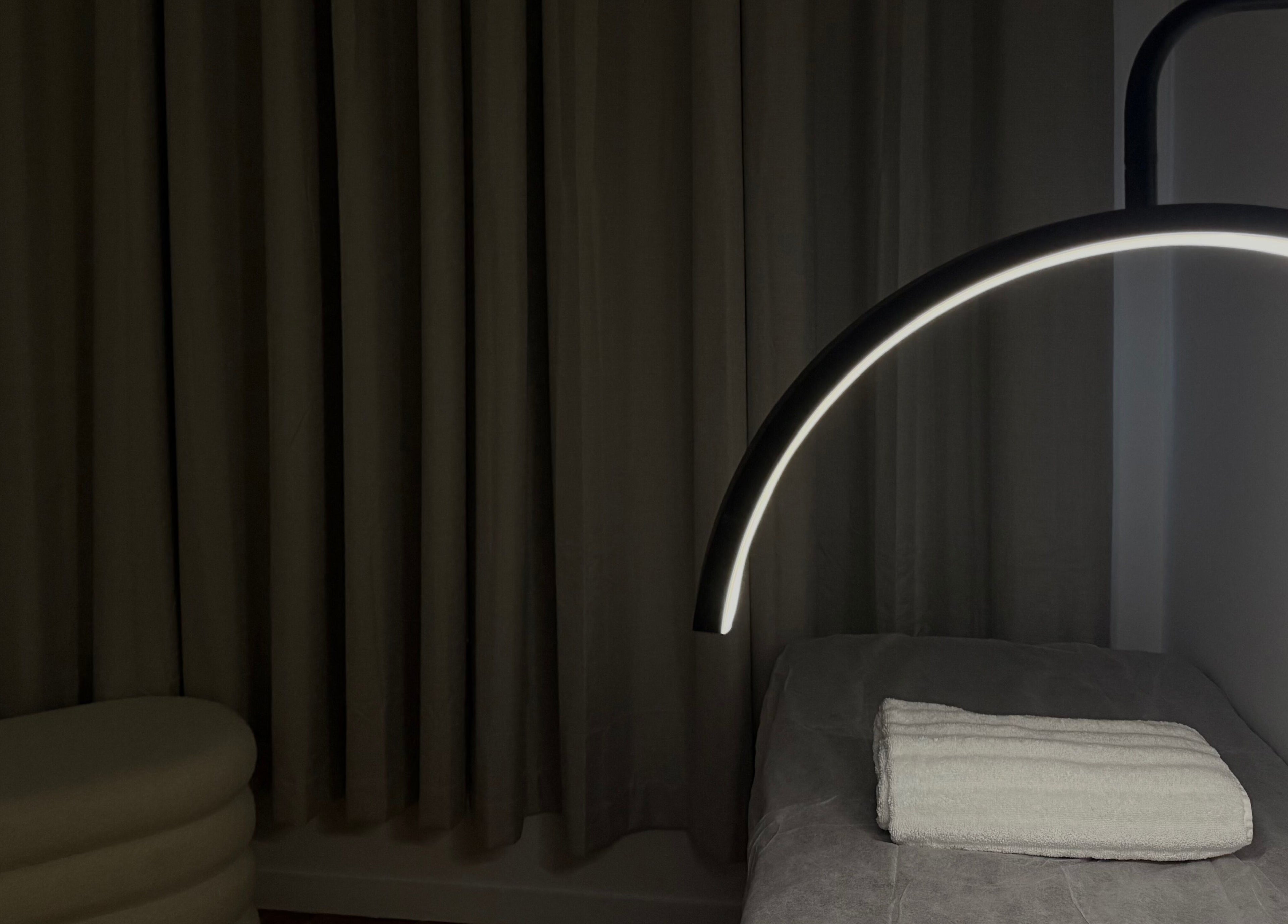 Tranquil treatment room at Genesis GloMed, Toongabbie, NSW AU features ambient lighting and cozy setting.