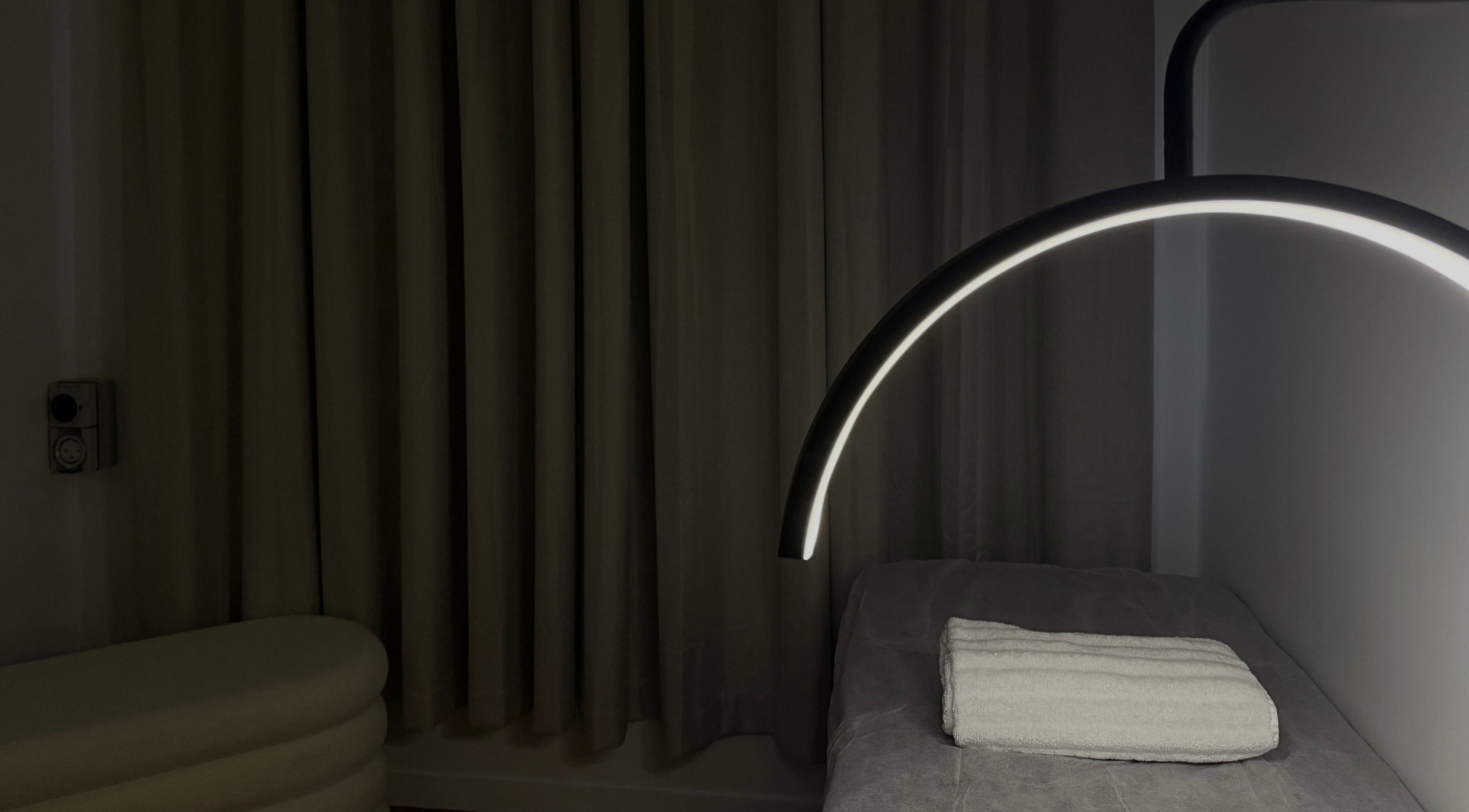 Tranquil treatment room at Genesis GloMed, Toongabbie, NSW AU features ambient lighting and cozy setting.