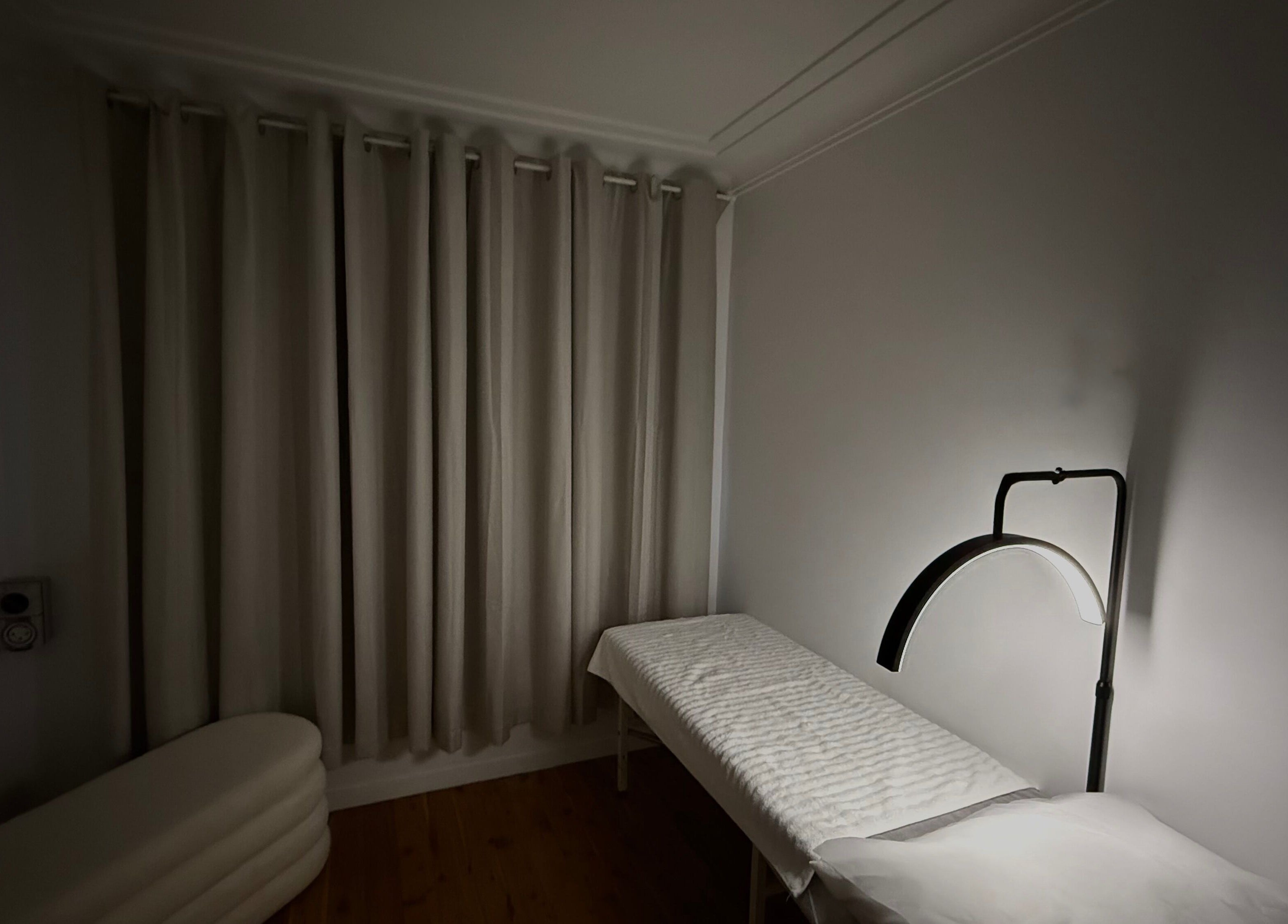 Peaceful therapy room at Genesis GloMed, Toongabbie, New South Wales, AU, featuring a treatment bed and lamp.