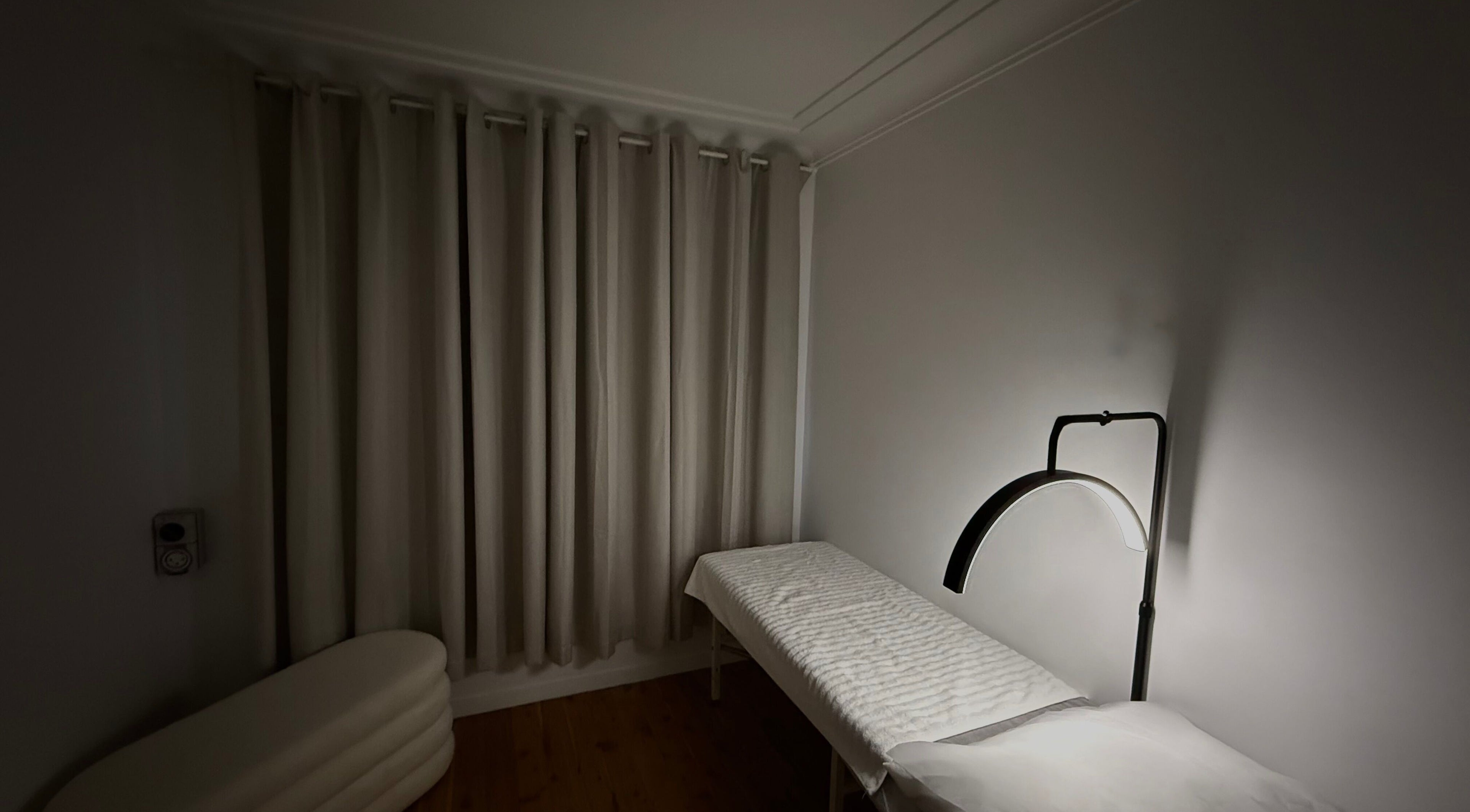 Peaceful therapy room at Genesis GloMed, Toongabbie, New South Wales, AU, featuring a treatment bed and lamp.