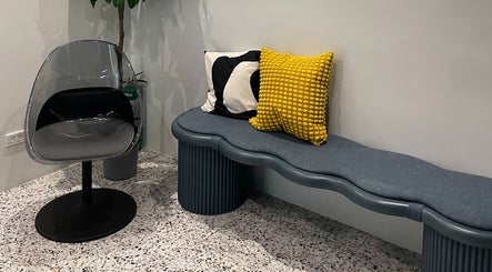 Modern seating area at Piercing Day, Taguig, Metro Manila, PH with stylish chairs and cushions.