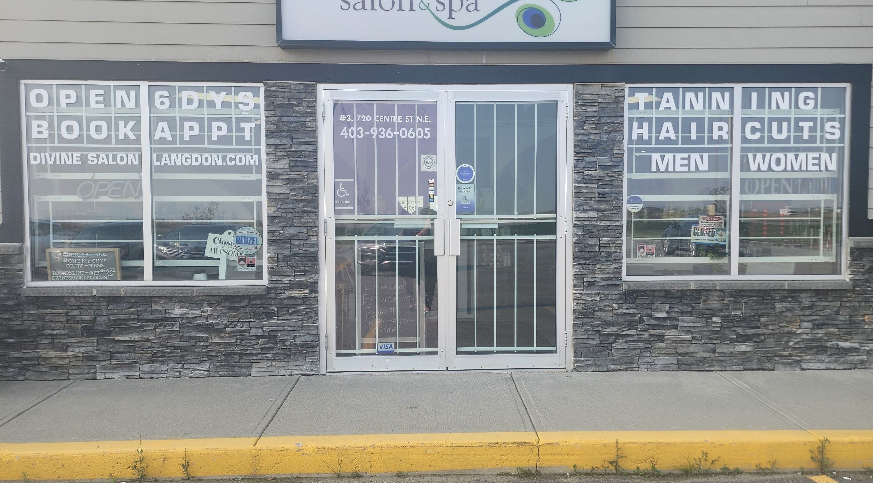 Front entrance of Divine Salon and Spa in Langdon, Alberta, CA with booking signs.