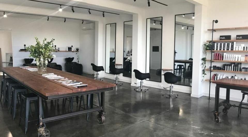 Modern interior of HQ Salon and Beauty in Aspendale, Victoria, AU with styling chairs and product shelves.