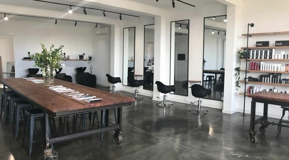 Modern interior of HQ Salon and Beauty in Aspendale, Victoria, AU with styling chairs and product shelves.
