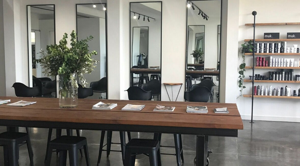 Elegant salon interior of HQ Salon and Beauty, Aspendale, Victoria, AU with mirrors and lush greenery.