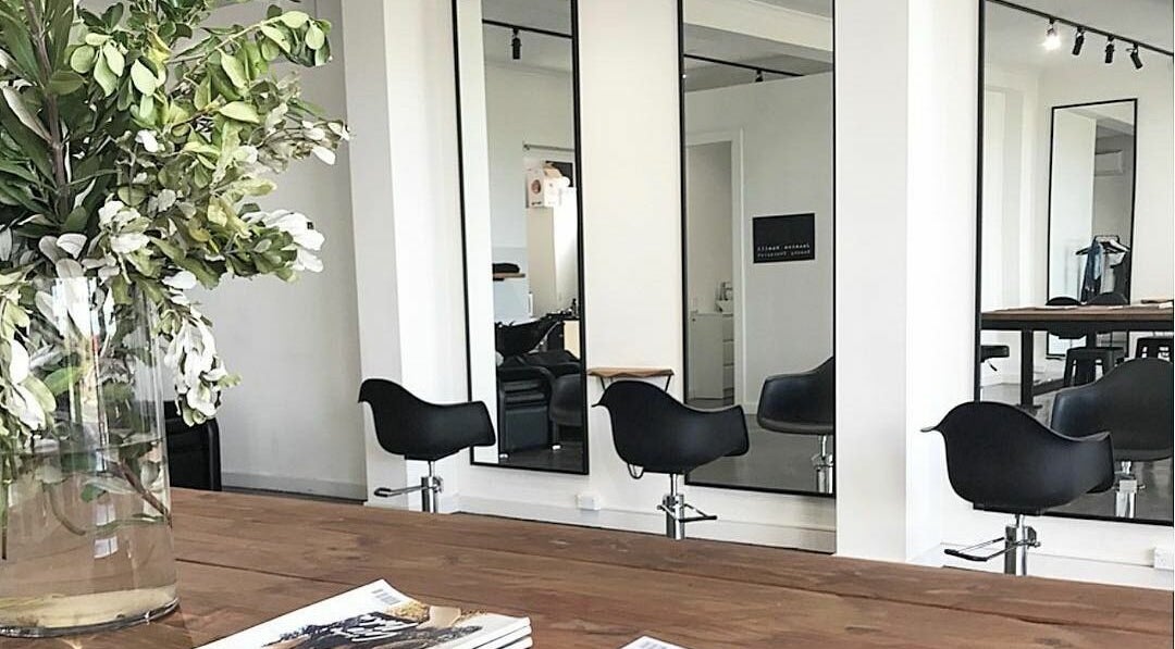 Elegantly designed salon area at HQ Salon and Beauty, Aspendale, Victoria, AU with mirrors and chairs.